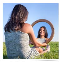 Woman looking in the mirror.