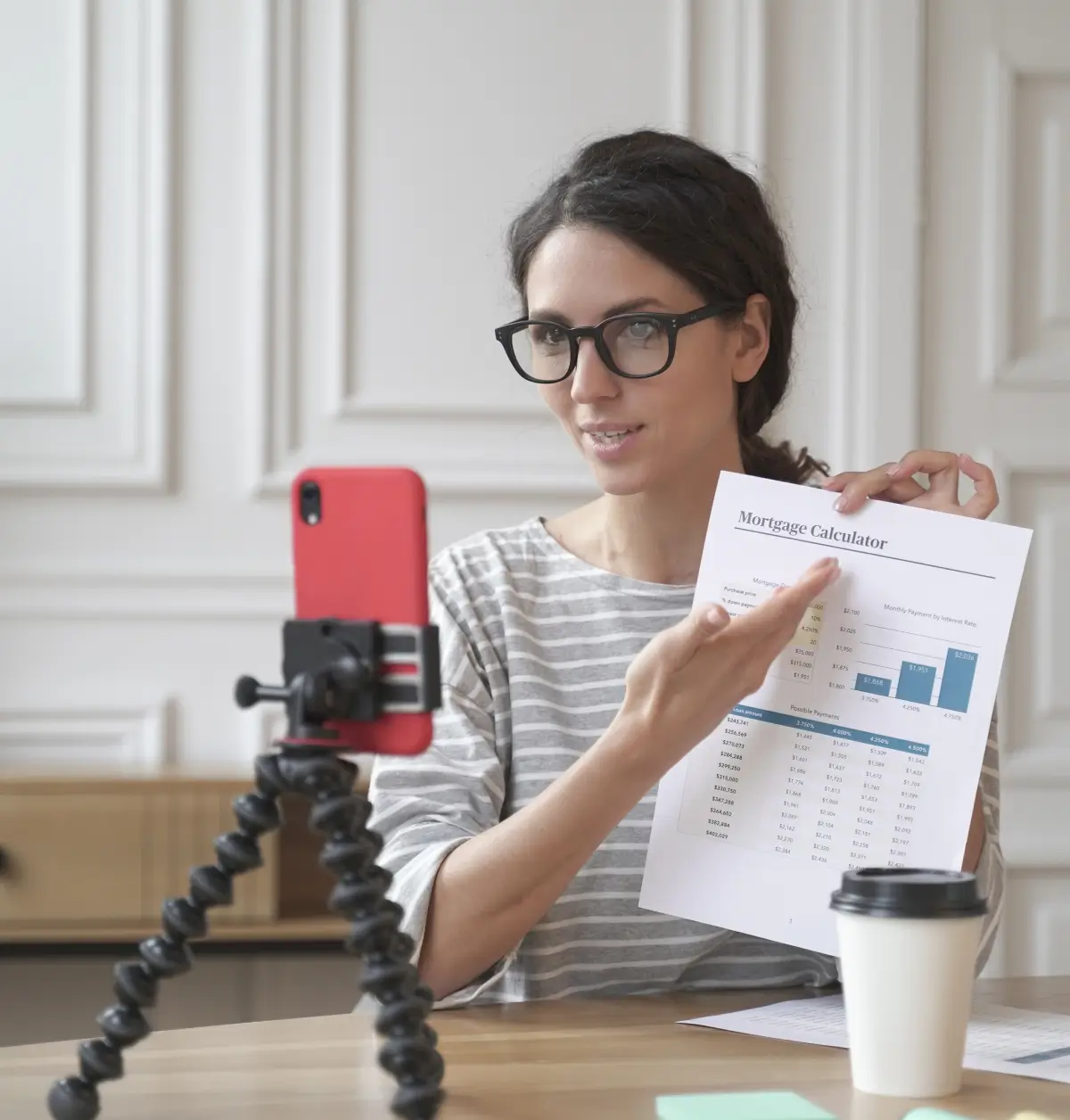 Real estate influencer presenting a mortgage calculator document on camera for social media content.