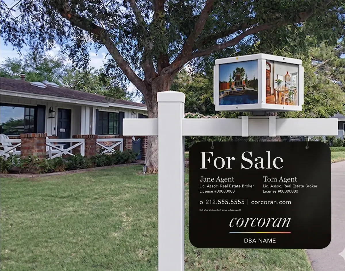 Corcoran for sale sign hanging from a white post with a photo display box attachment in front of a brick ranch home