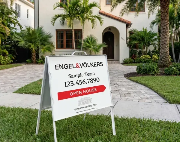 Engel and Volkers open house A-frame sign in front of white stucco home.