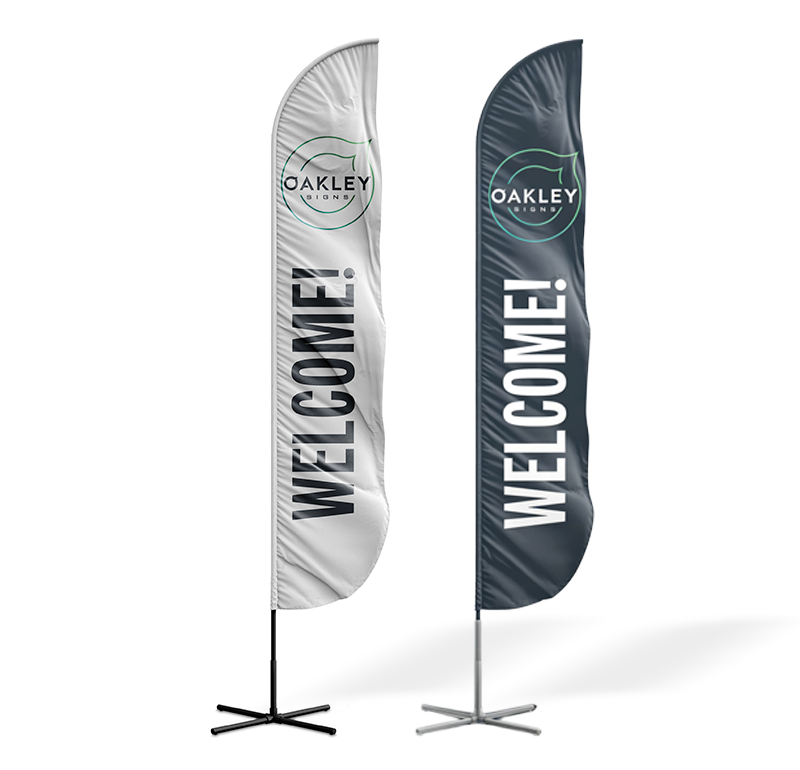Branded real estate flags posted at a driveway entrance during an open house event.
