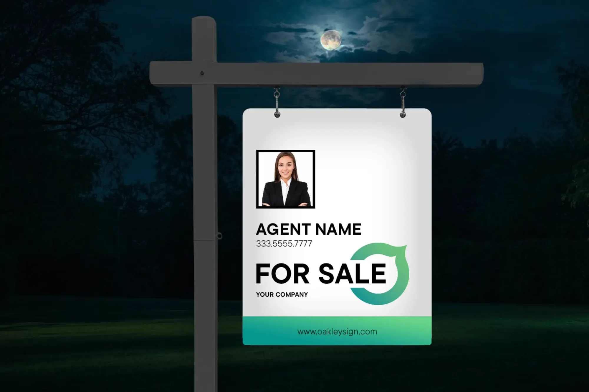 Reflective real estate for sale sign hanging on a post at night under a full moon.